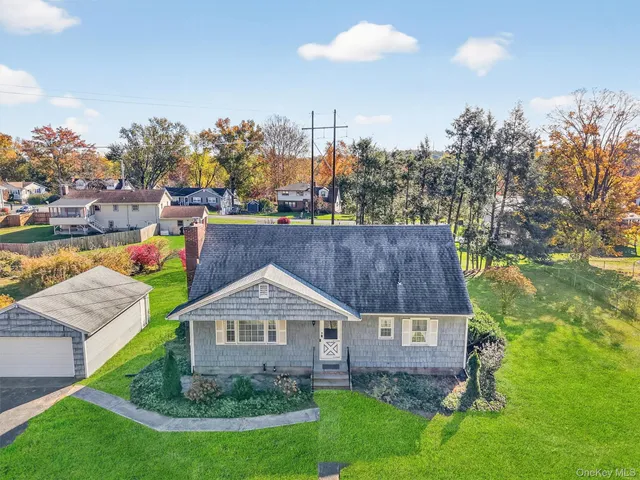 a view of a house with a yard and a garden
