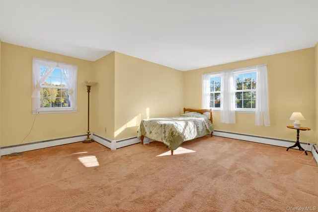 a spacious bedroom with a bed and a window