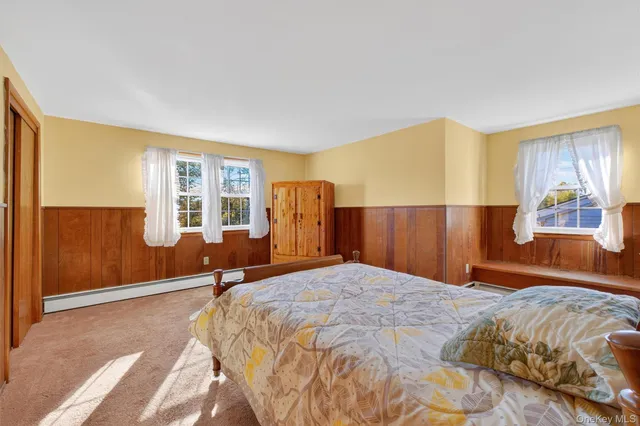 a bedroom with a large bed and a window