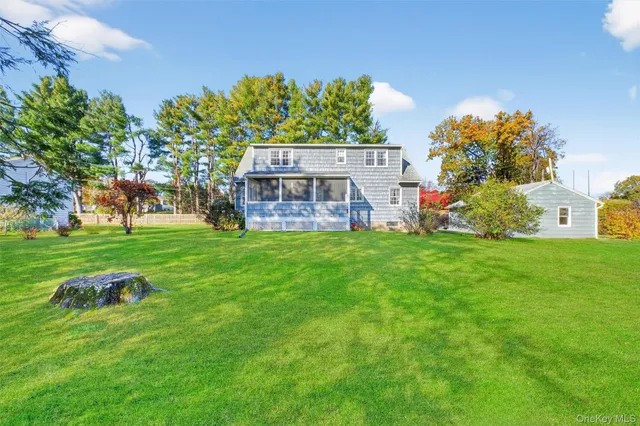 a view of a house with a big yard and potted plants