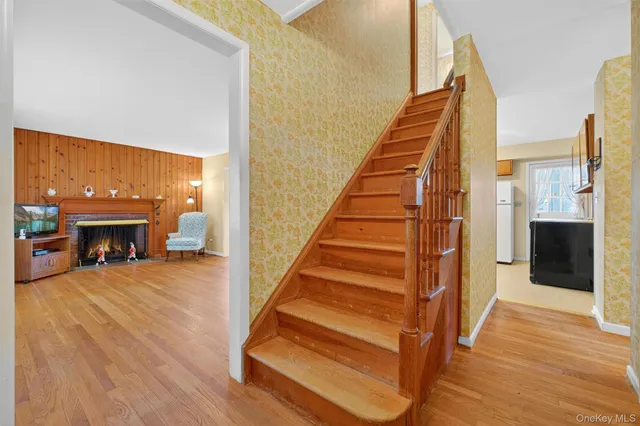 a view of a livingroom with wooden floor and a fireplace