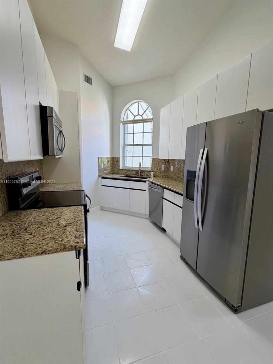 3951 Redondo Court Boca Raton, FL 33487 - Photo 14 of 30 a kitchen with stainless steel appliances granite countertop a refrigerator and a stove top oven