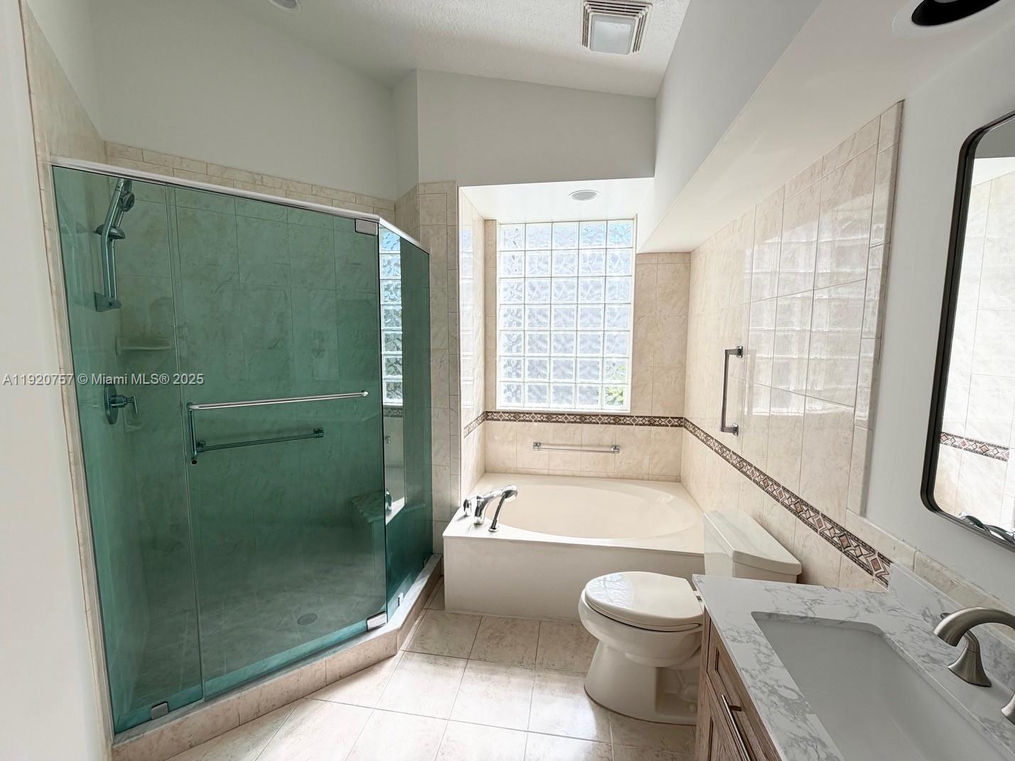 3951 Redondo Court Boca Raton, FL 33487 - Photo 16 of 30 a bathroom with a granite countertop bathtub shower sink vanity and toilet