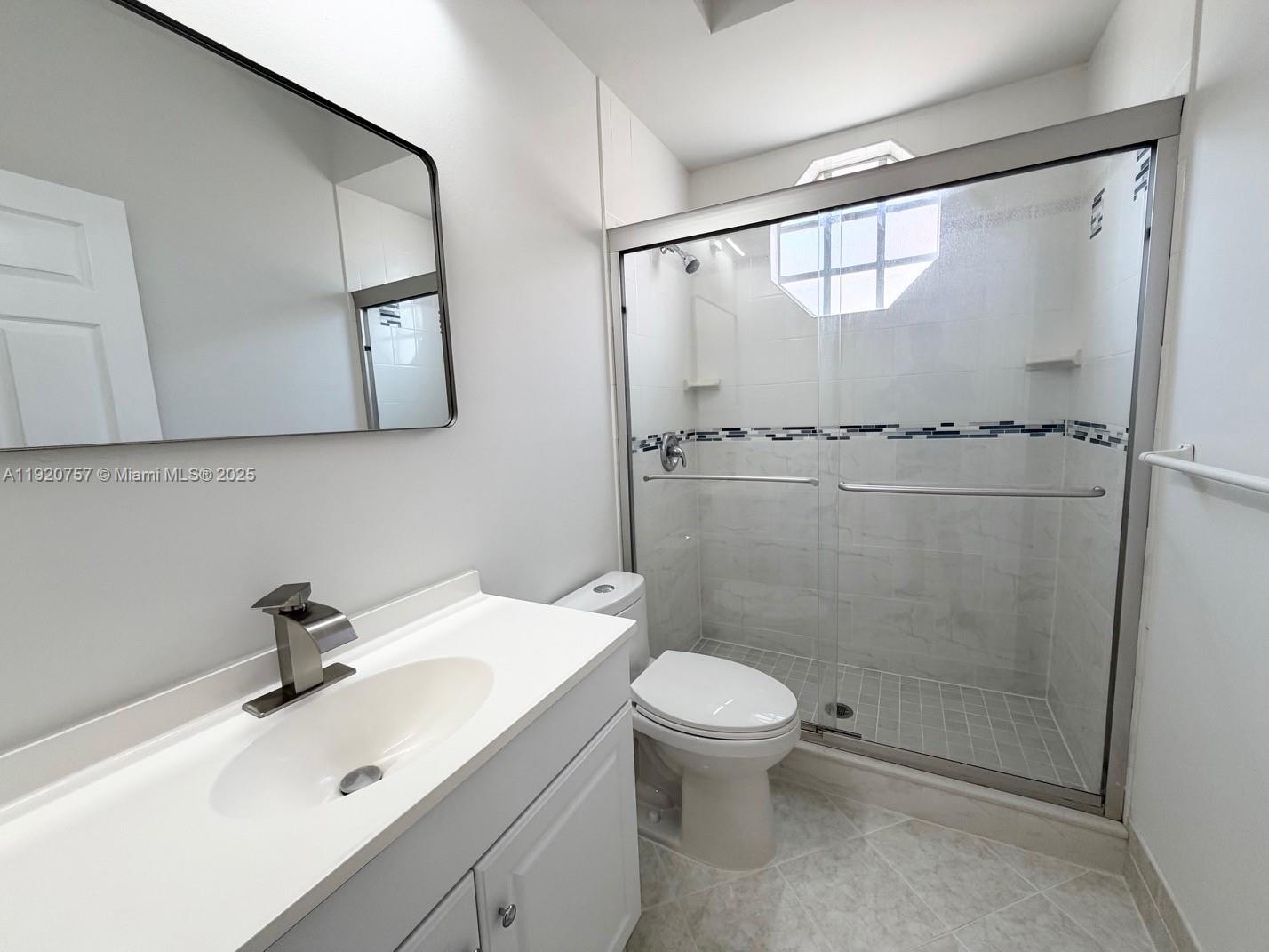 3951 Redondo Court Boca Raton, FL 33487 - Photo 17 of 30 a bathroom with a sink a toilet and shower