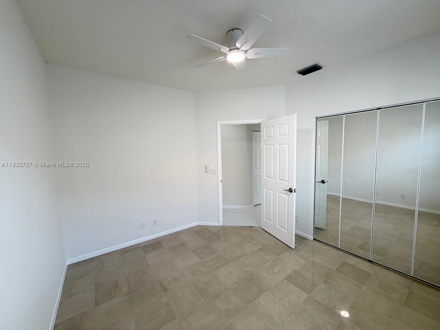 3951 Redondo Court Boca Raton, FL 33487 - Photo 23 of 30 an empty room with closet and a ceiling fan