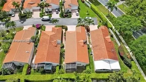 an aerial view of a house with a yard and trees