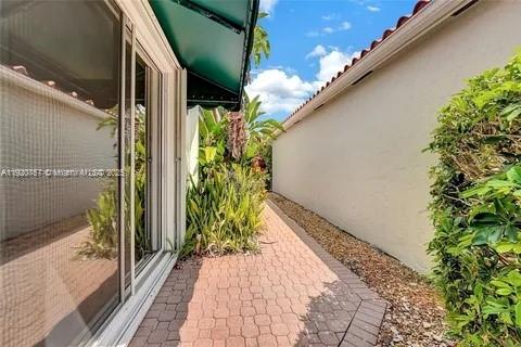 3951 Redondo Court Boca Raton, FL 33487 - Photo 9 of 30 a view of a pathway both side of house