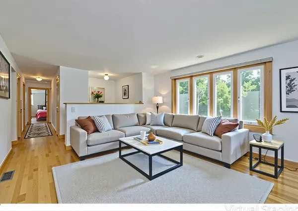 a living room with furniture and a large window