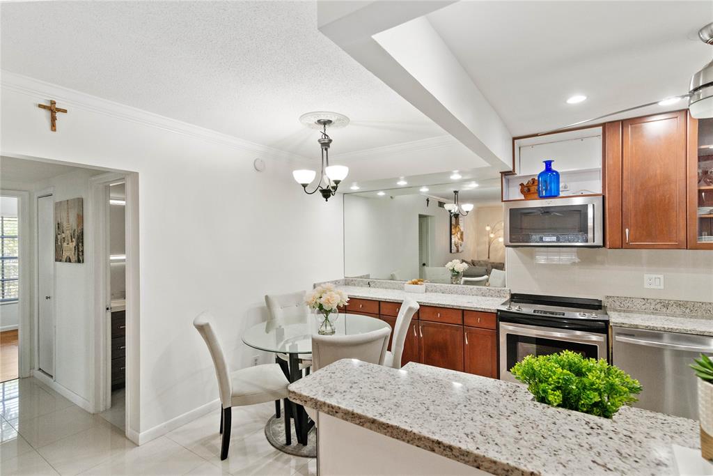 2151 Northeast 68th Street Fort Lauderdale, FL 33308 - Photo 11 of 45 a view of a dining room with furniture and a chandelier