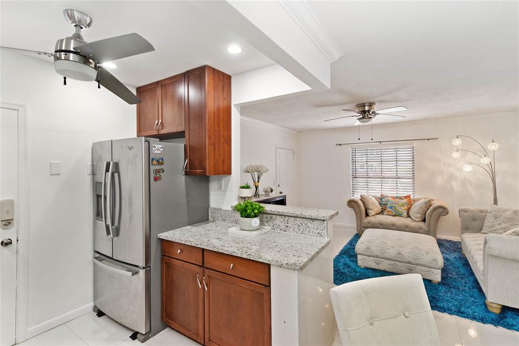 2151 Northeast 68th Street Fort Lauderdale, FL 33308 - Photo 14 of 45 a kitchen with stainless steel appliances granite countertop cabinets and a refrigerator