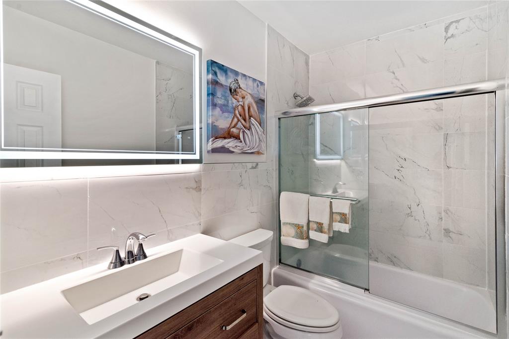 2151 Northeast 68th Street Fort Lauderdale, FL 33308 - Photo 16 of 45 a bathroom with a sink toilet a mirror and shower