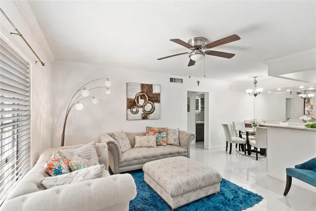 a living room with furniture and kitchen view