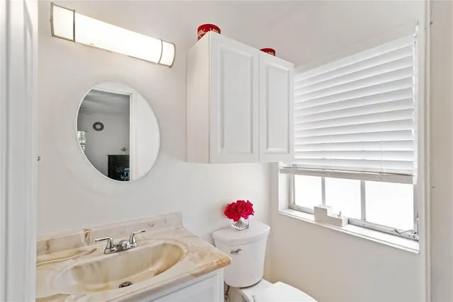 a bathroom with a sink mirror and window