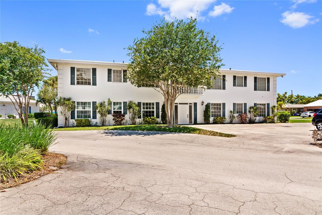2151 Northeast 68th Street Fort Lauderdale, FL 33308 - Photo 38 of 45 a front view of a house with a yard and garage
