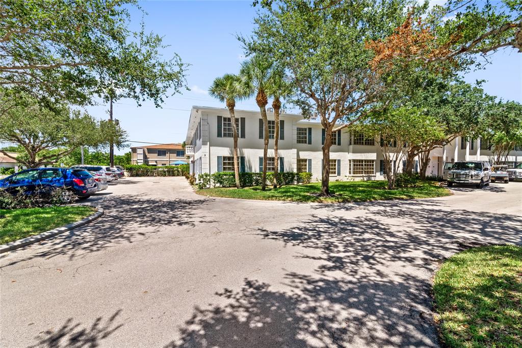 2151 Northeast 68th Street Fort Lauderdale, FL 33308 - Photo 39 of 45 a front view of a house with a garden and trees