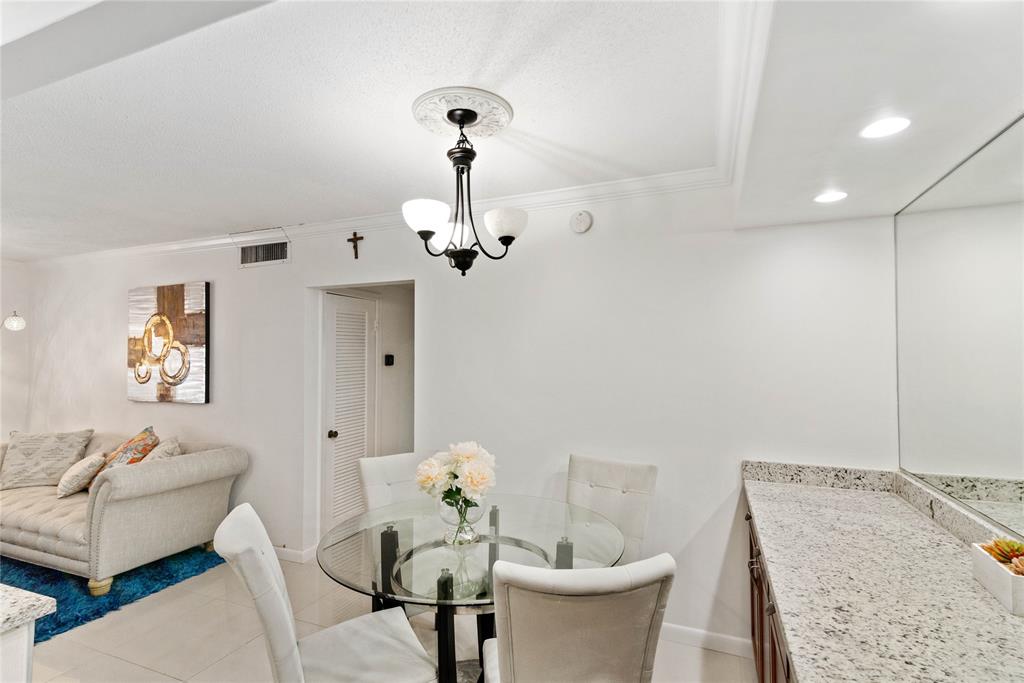 2151 Northeast 68th Street Fort Lauderdale, FL 33308 - Photo 9 of 45 a view of a dining room with furniture and wooden floor