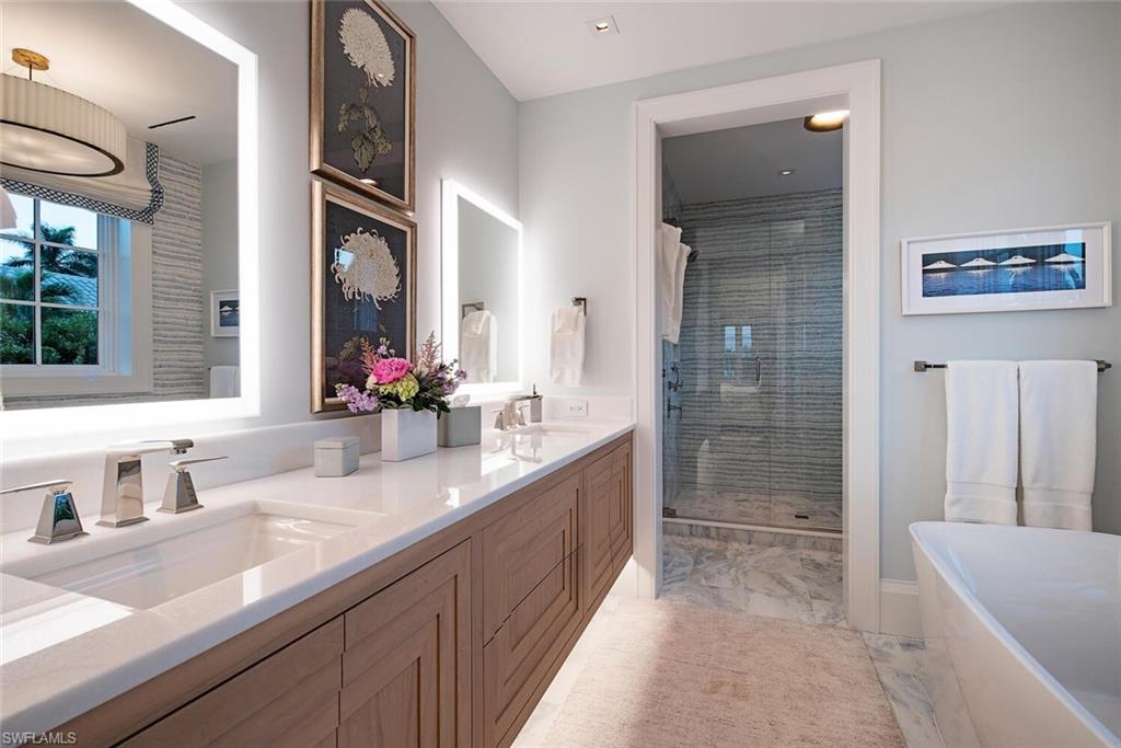 4115 Cutlass Lane Naples, FL 34102 - Photo 20 of 44 a bathroom with a granite countertop sink mirror and double