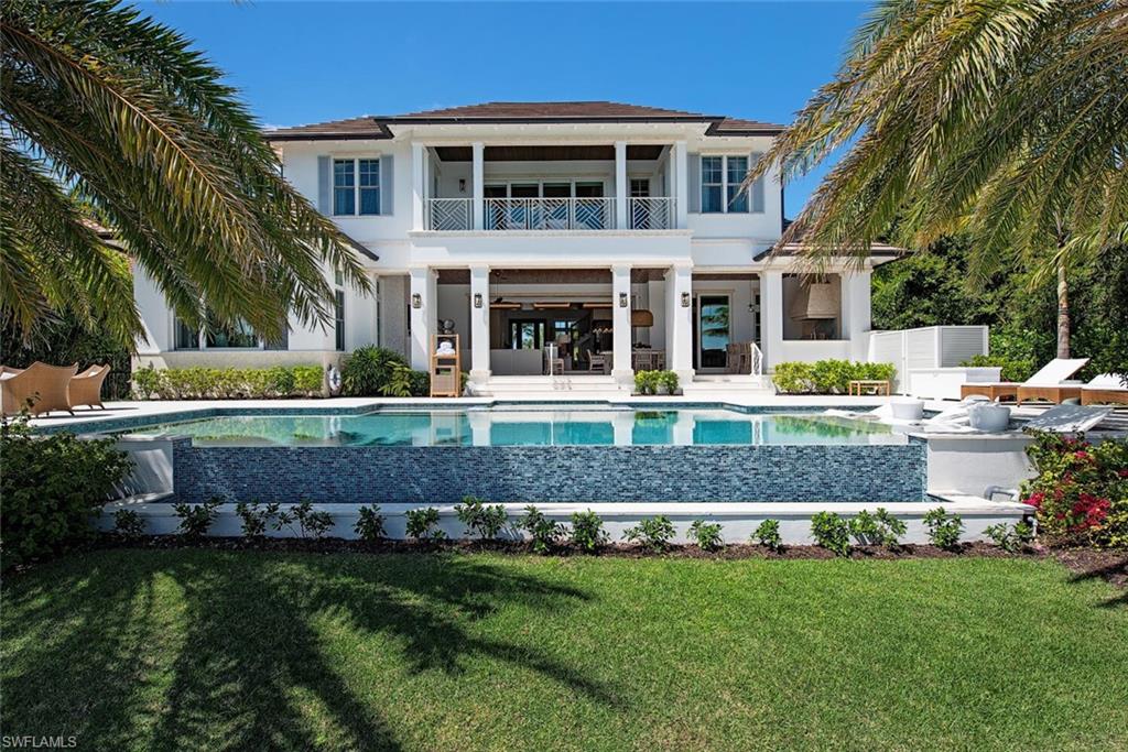 4115 Cutlass Lane Naples, FL 34102 - Photo 33 of 44 a front view of a house with a yard