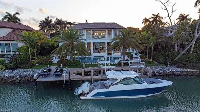 an aerial view of a city with lots of residential buildings and lake view in back