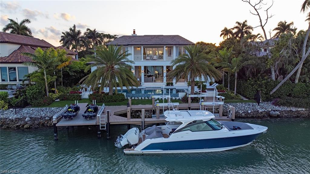 4115 Cutlass Lane Naples, FL 34102 - Photo 35 of 44 a view of a house with backyard water fountain and sitting area