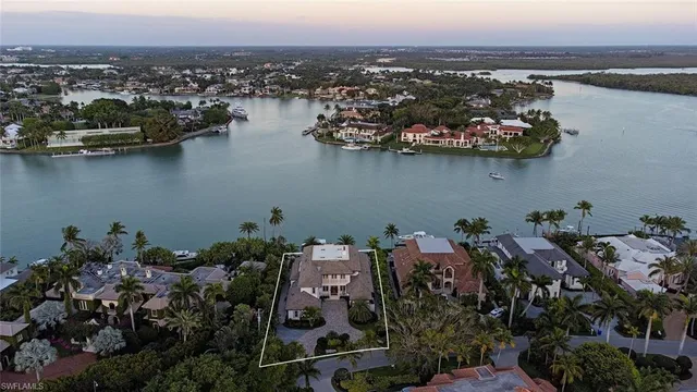 a aerial view of a house with a garden and lake view
