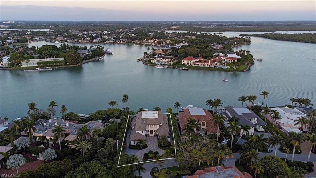 4115 Cutlass Lane Naples, FL 34102 - Photo 36 of 44 an aerial view of a city with lots of residential buildings and lake view in back