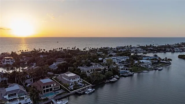 an aerial view of a houses with ocean view