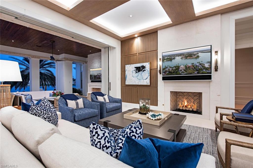 4115 Cutlass Lane Naples, FL 34102 - Photo 4 of 44 a living room with furniture and a fireplace