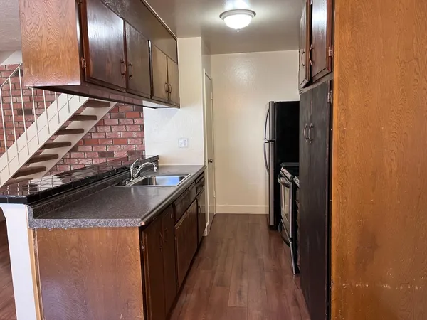 a kitchen with stainless steel appliances granite countertop a refrigerator and a sink