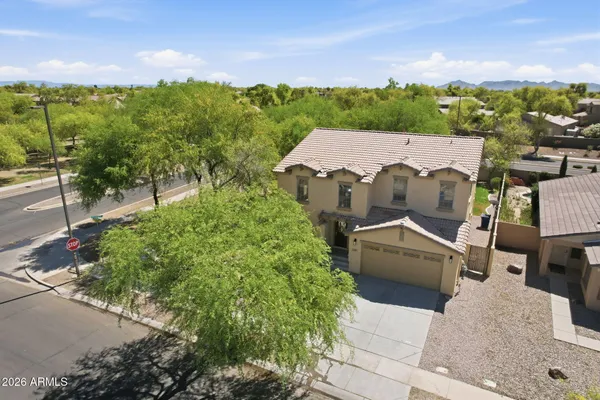 an aerial view of residential houses with outdoor space and trees
