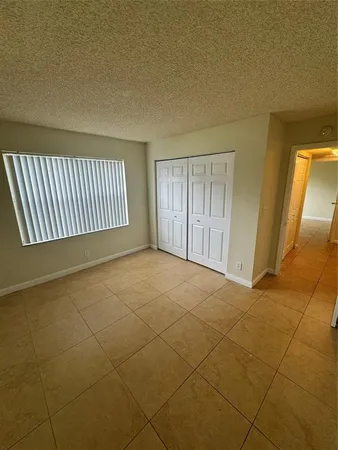 a view of an empty room and a window