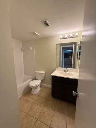 a bathroom with a sink toilet and mirror