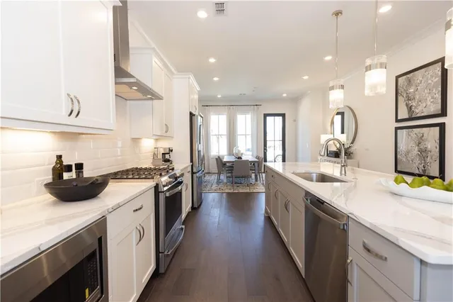 a kitchen with a sink stove and cabinets
