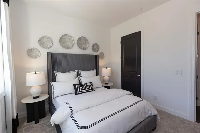 a bedroom with a bed and lamp