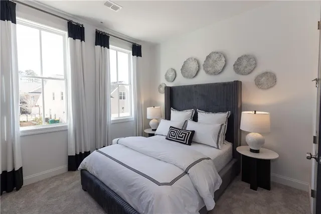 a bedroom with a large bed and a window