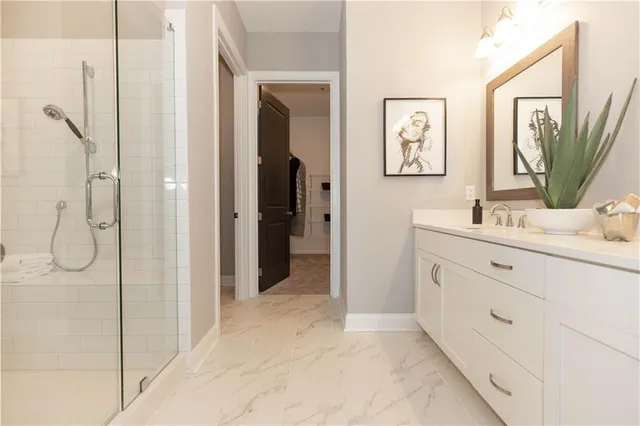 a bathroom with a double vanity sink mirror and shower