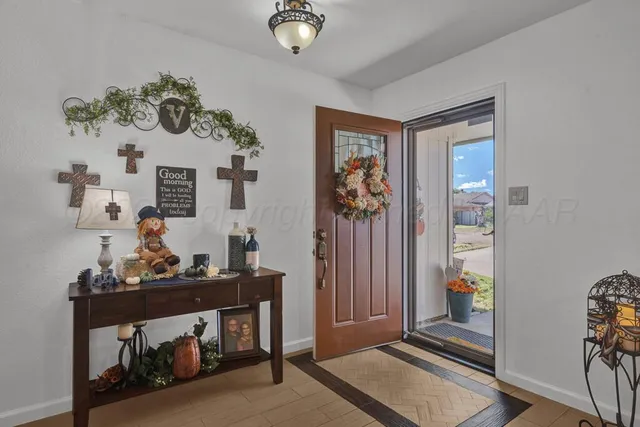 a room with painting on the wall and a table