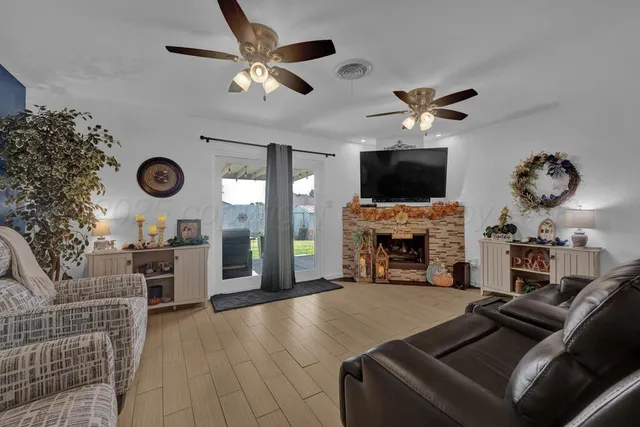 a living room with furniture a fireplace and a flat screen tv