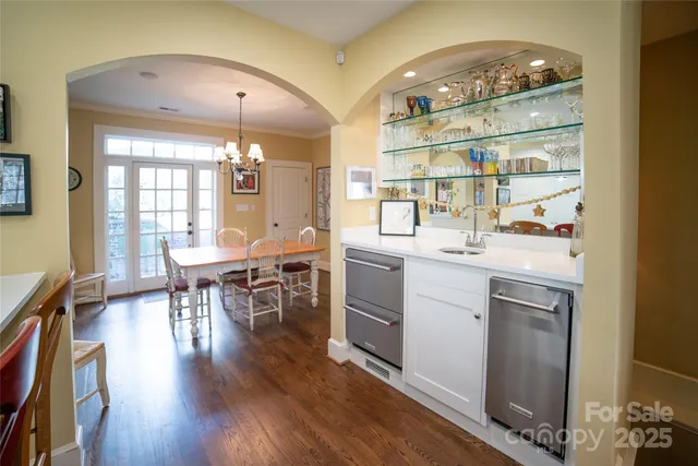 a kitchen with a sink cabinets and wooden floor