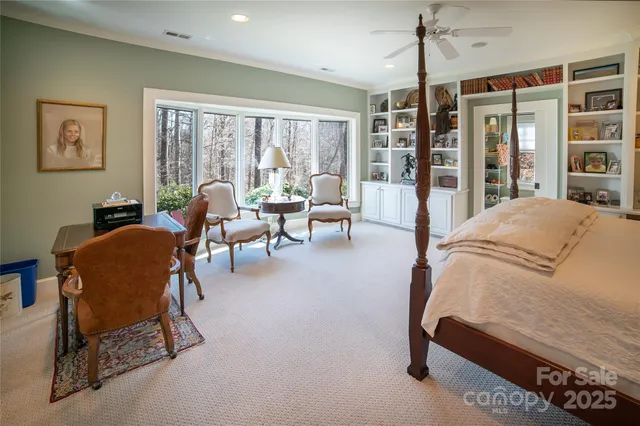 a living room with furniture and a floor to ceiling window