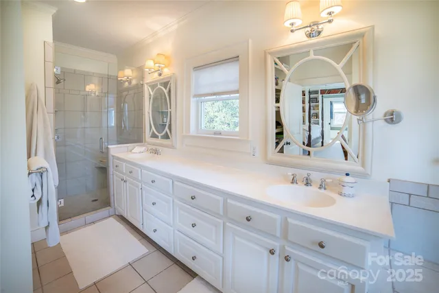 a spacious bathroom with double sink and a mirror