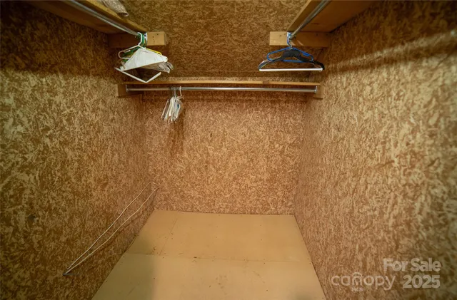 a bedroom with a bed and a dresser with bookshelf