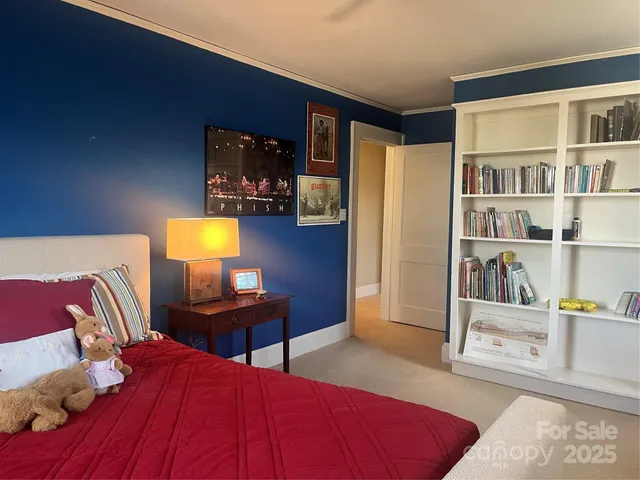 a bedroom with a bed and a fireplace