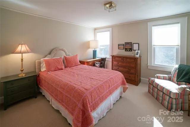 a view of empty room with a fireplace and a window