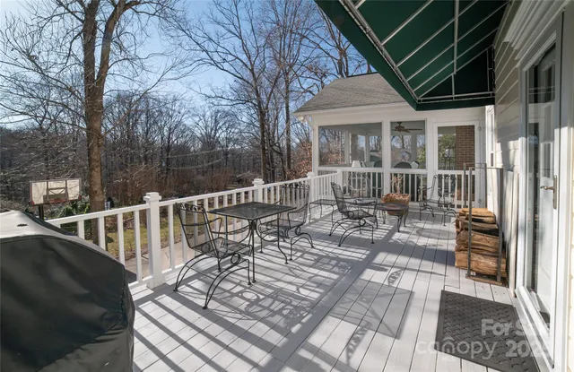 a balcony with wooden floor and outdoor seating