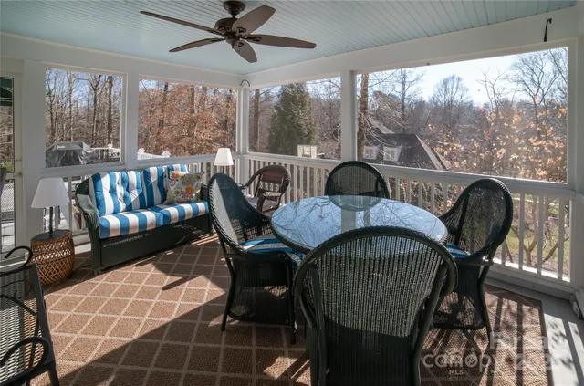 a dining room with furniture and a floor to ceiling window