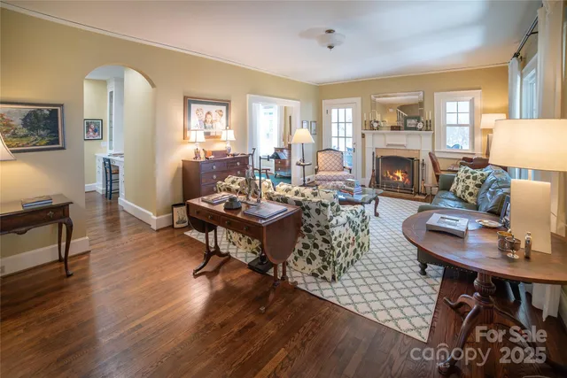 a living room with furniture a fireplace and a window