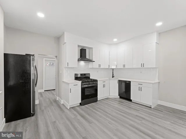 a kitchen with a refrigerator stove top oven and sink