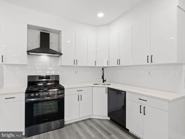 a kitchen with cabinets appliances and a sink