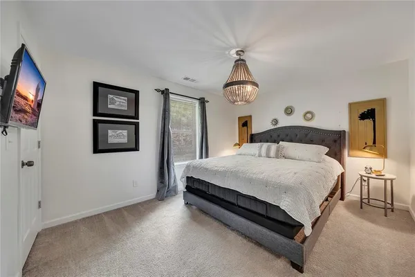 a bedroom with a bed and a flat screen tv